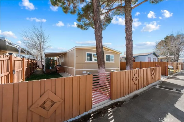 a view of a house with a tree in front of it