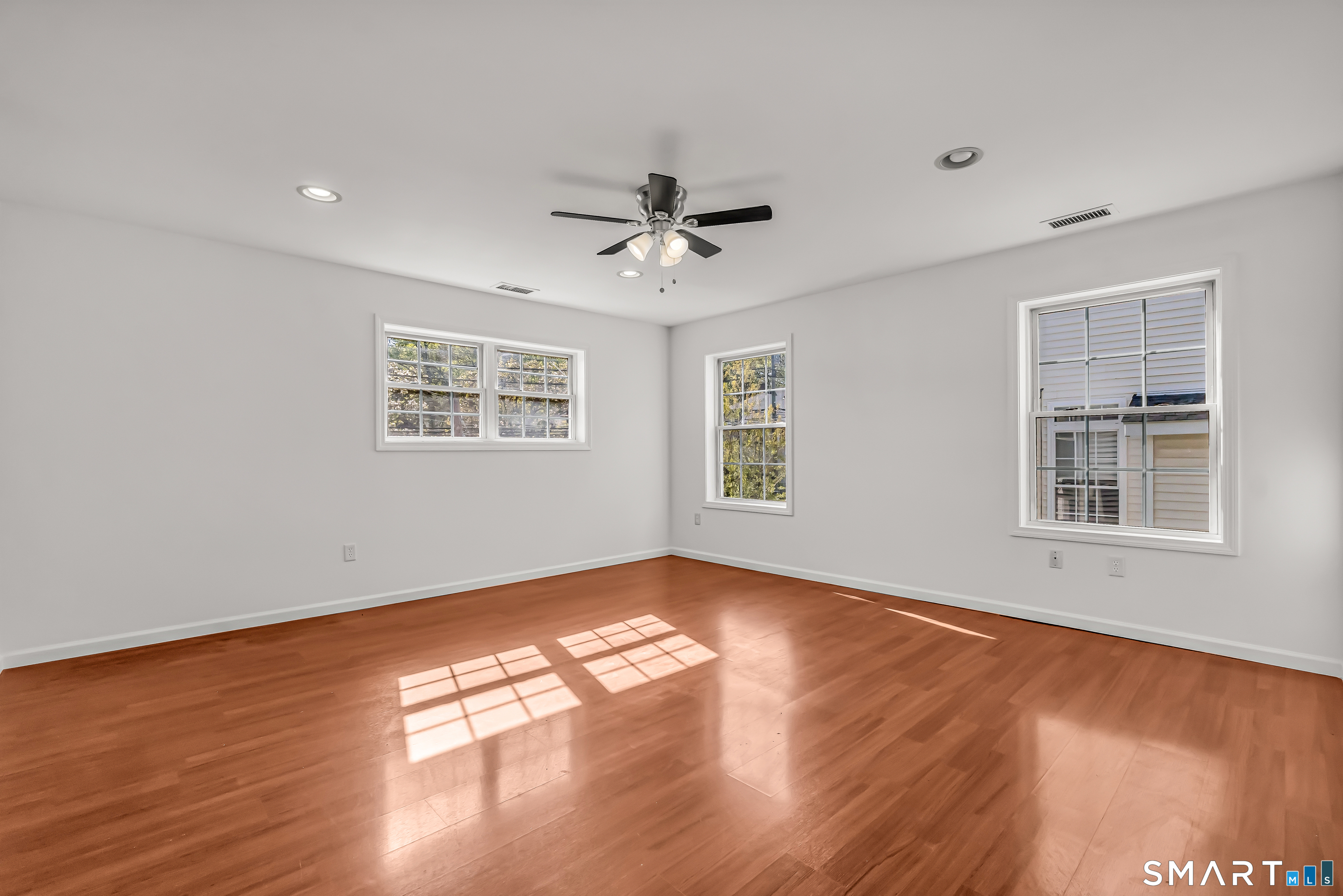1770 Stratfield Road Fairfield, CT 06825 - Photo 27 of 40 a view of empty room with wooden floor and fan