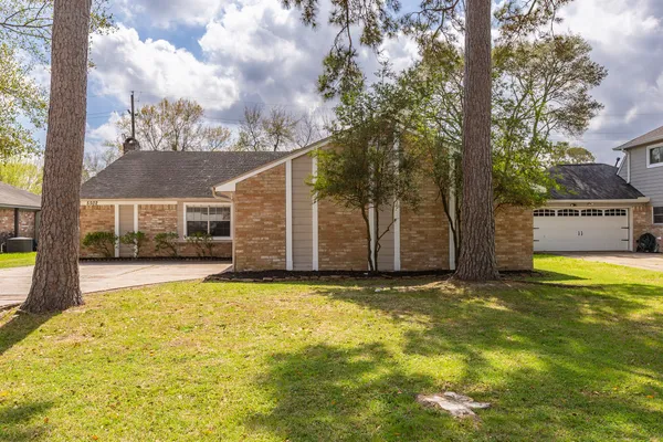 a view of a house with pool and a yard