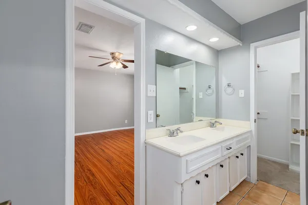 a bathroom with a sink a mirror and a shower