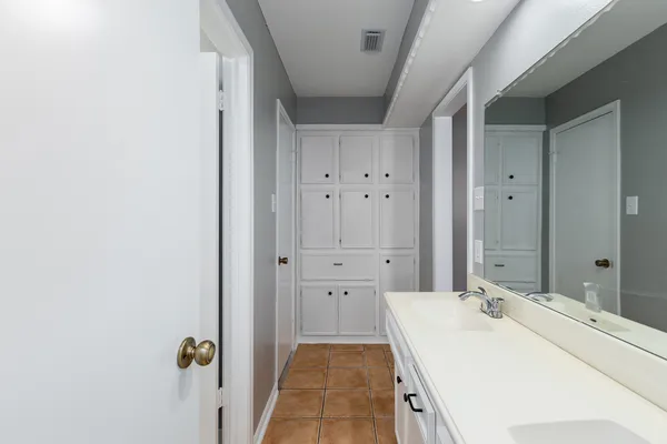 a large bathroom with a sink and mirror