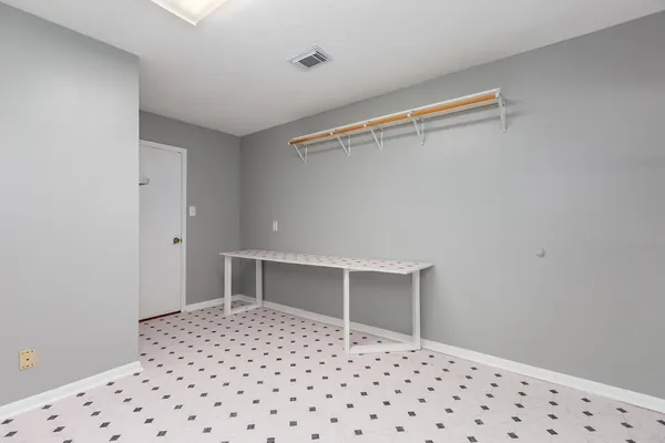 a room with a walk in closet and wooden floor