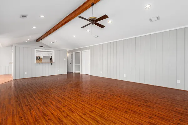 wooden floor in an empty room with a ceiling fan