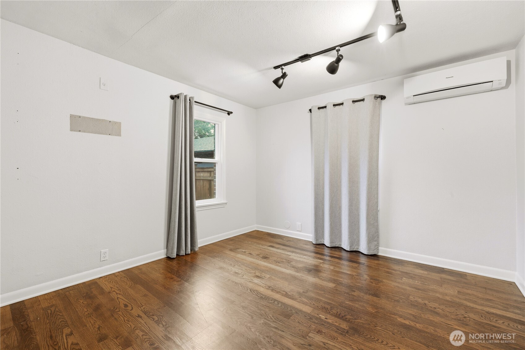 226 Southwest 131st Street Burien, WA 98146 - Photo 14 of 25 an empty room with wooden floor and windows