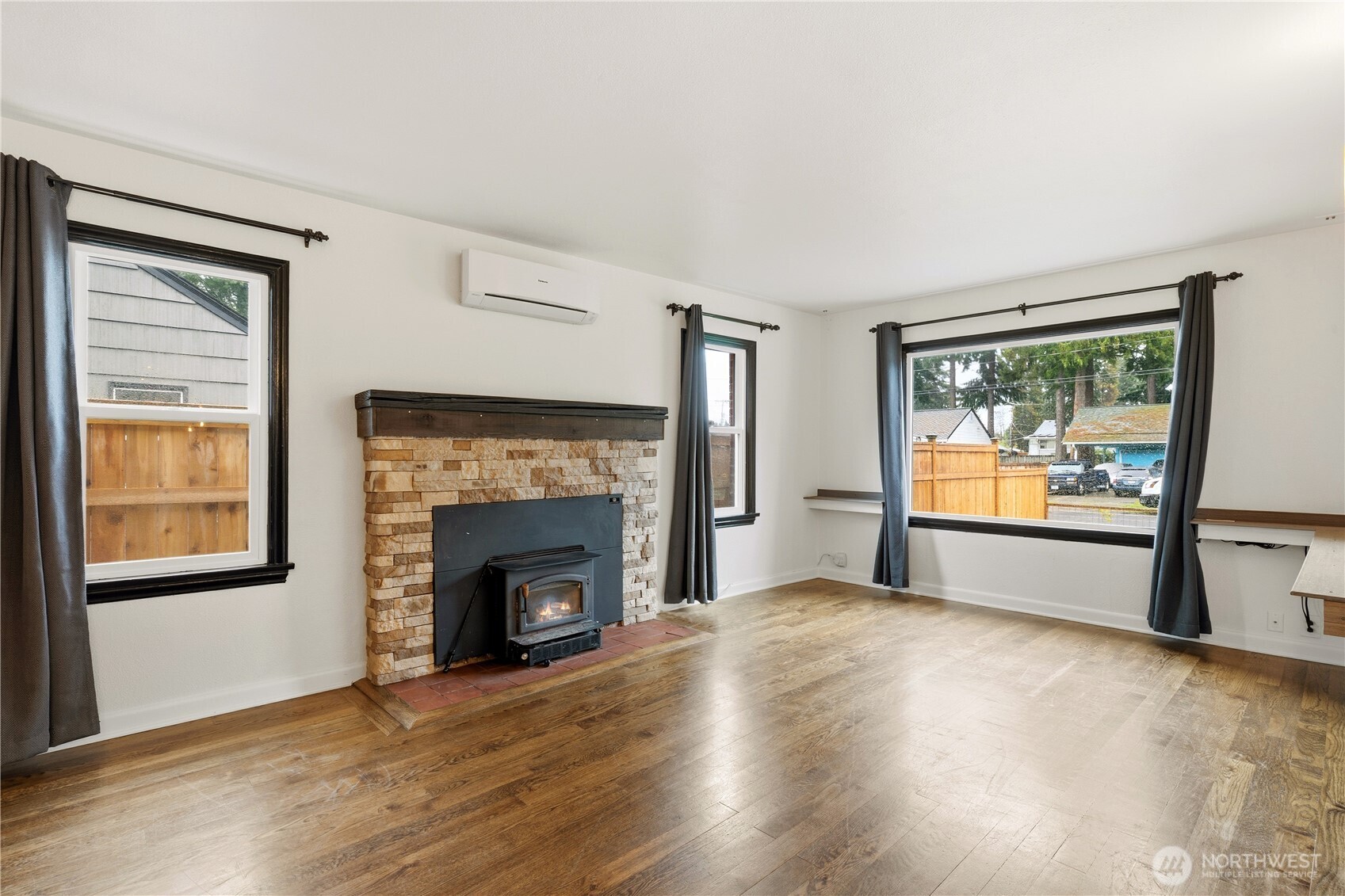 226 Southwest 131st Street Burien, WA 98146 - Photo 2 of 25 a view of empty room with wooden floor and fireplace