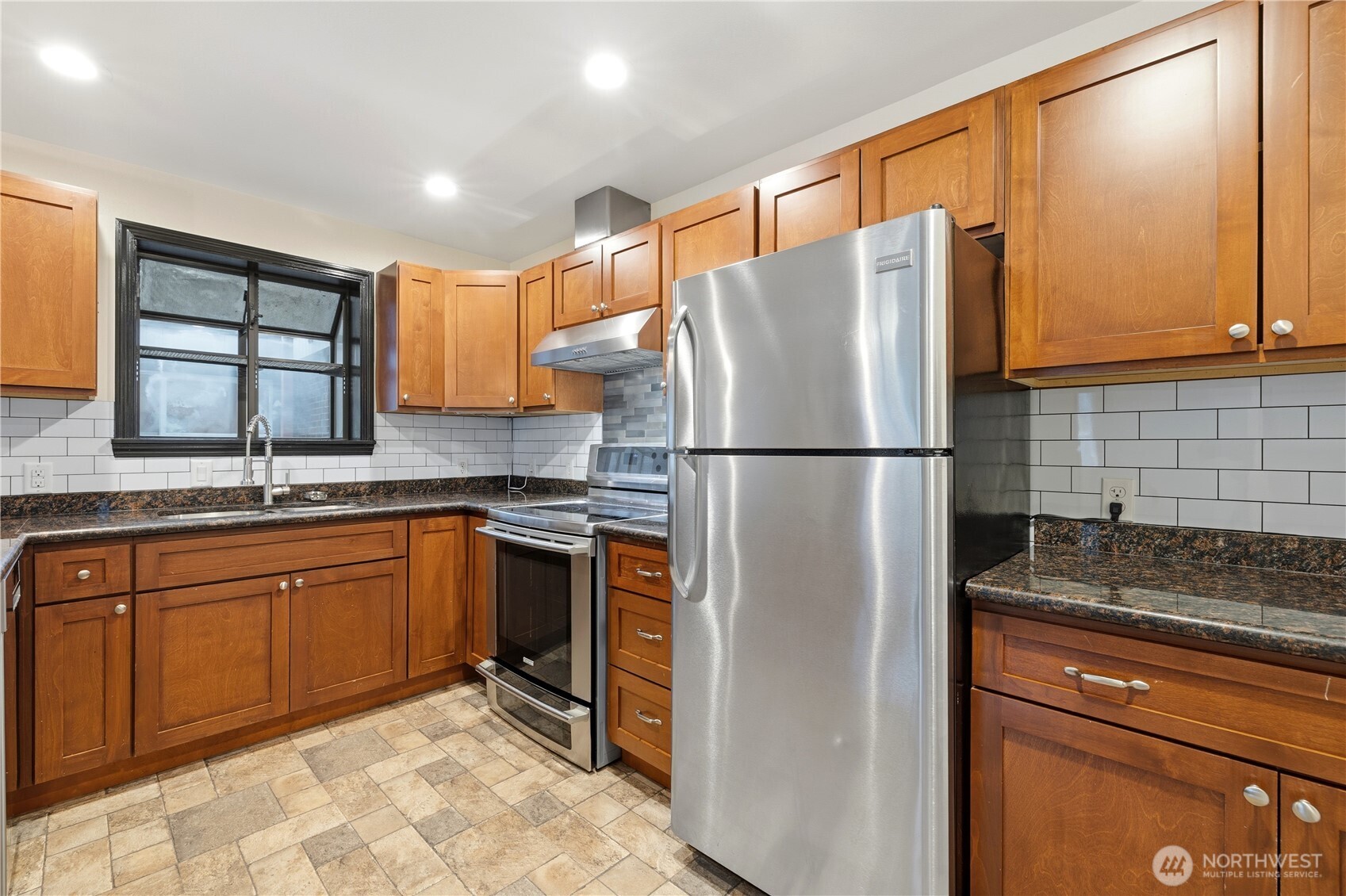 226 Southwest 131st Street Burien, WA 98146 - Photo 6 of 25 a kitchen with stainless steel appliances granite countertop a refrigerator and a sink