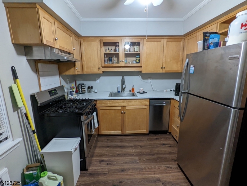 18 The Crescent, Unit 8 Montclair, NJ 07042 - Photo 4 of 8 a kitchen with a sink a refrigerator a stove a washer dryer and cabinets