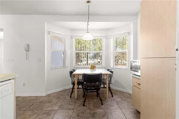 a view of a dining room with furniture window and outside view