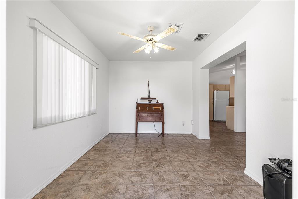 6115 Southwest 104th Street Ocala, FL 34476 - Photo 16 of 39 a view of a livingroom with a piano and wooden floor