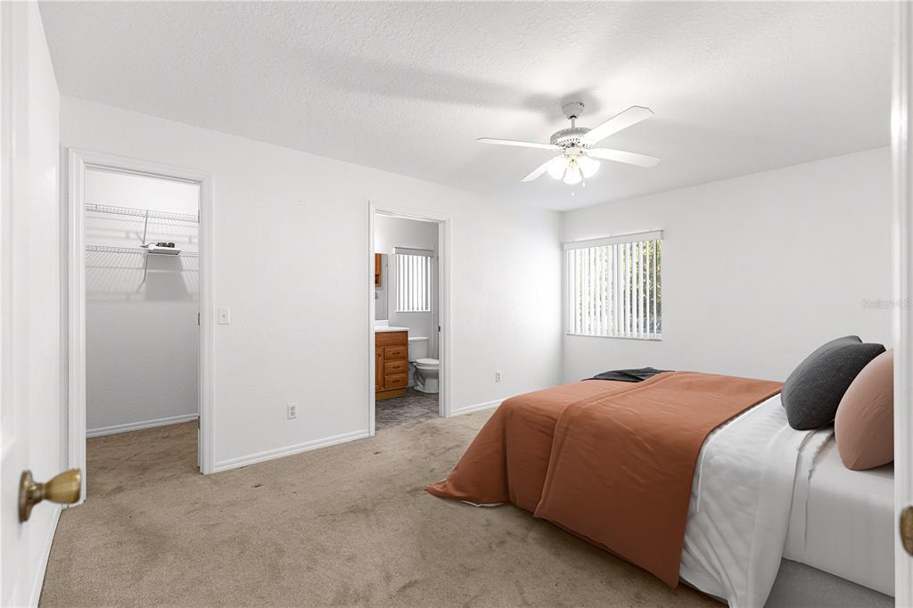 6115 Southwest 104th Street Ocala, FL 34476 - Photo 19 of 39 a bedroom with a bed and a chandelier fan
