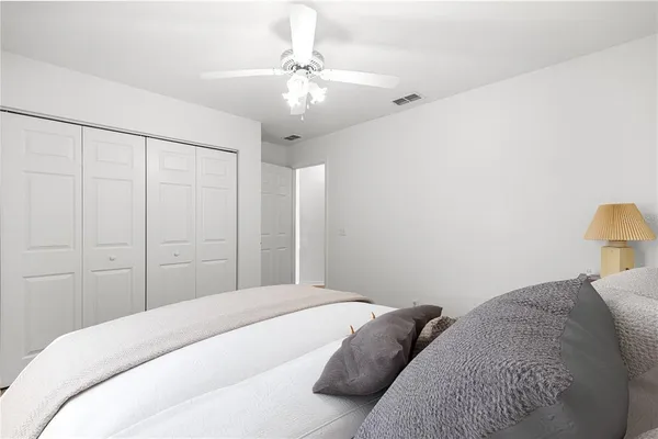 a bedroom with a large bed and a chandelier