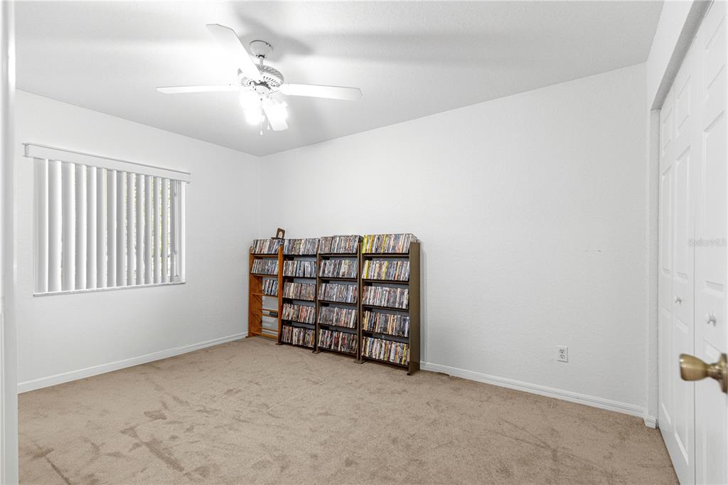 6115 Southwest 104th Street Ocala, FL 34476 - Photo 25 of 39 an empty room with windows and ceiling fan