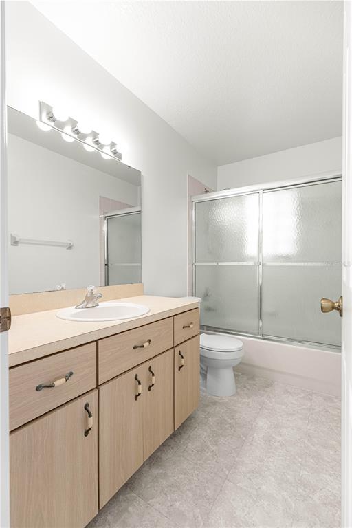 6115 Southwest 104th Street Ocala, FL 34476 - Photo 25 of 39 a bathroom with a toilet a sink and mirror