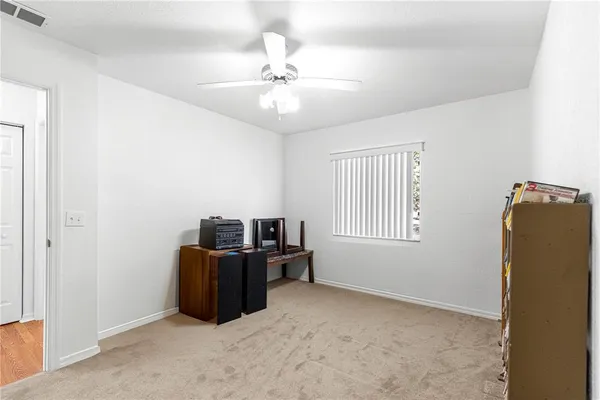a view of a livingroom with furniture and chandelier fan