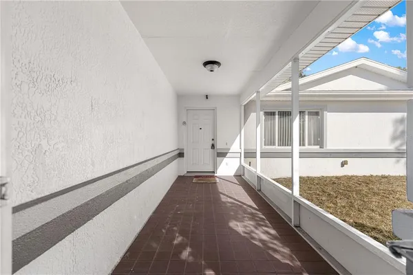a view of a large white room with wooden floor