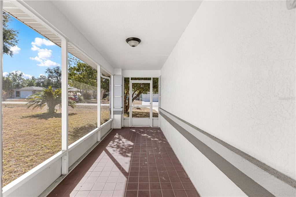 6115 Southwest 104th Street Ocala, FL 34476 - Photo 3 of 39 a view of a balcony with mountain view and wooden floor
