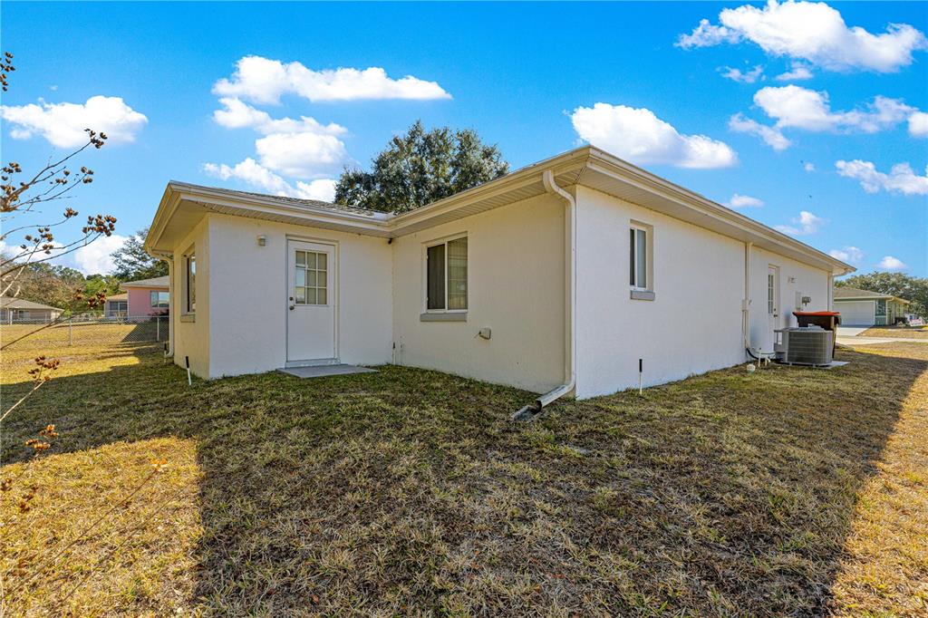 6115 Southwest 104th Street Ocala, FL 34476 - Photo 32 of 39 a view of a house with a backyard