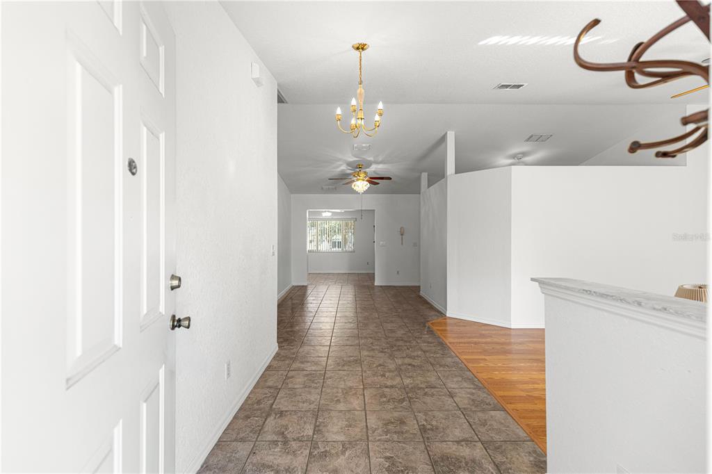 6115 Southwest 104th Street Ocala, FL 34476 - Photo 4 of 39 a view of a hallway with chandelier