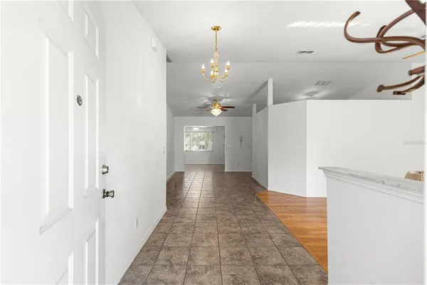a view of a hallway with chandelier