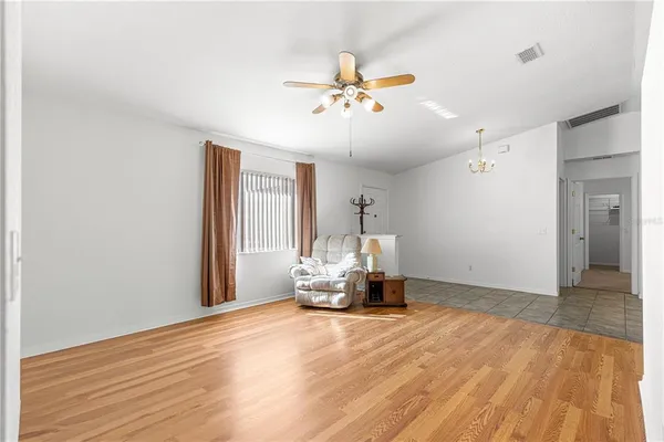 a view of a room with a window and wooden floor