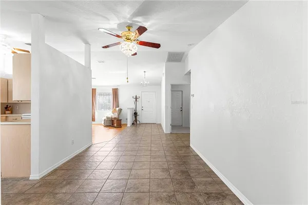 a view of a livingroom with a ceiling fan and window