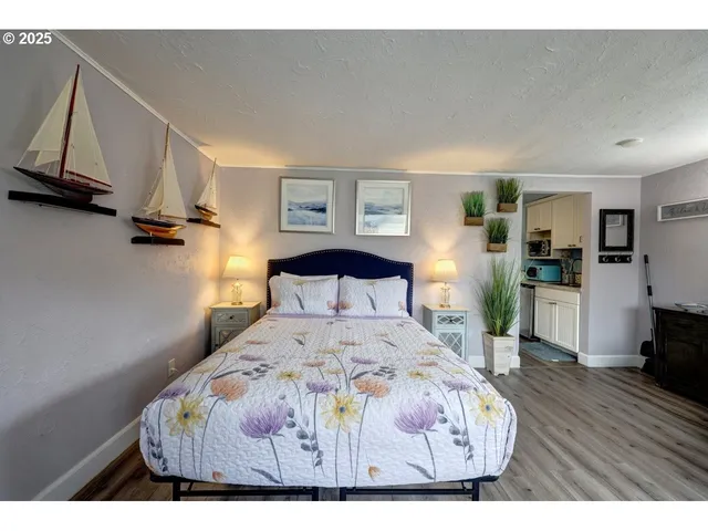 a bedroom with a bed and a view of kitchen