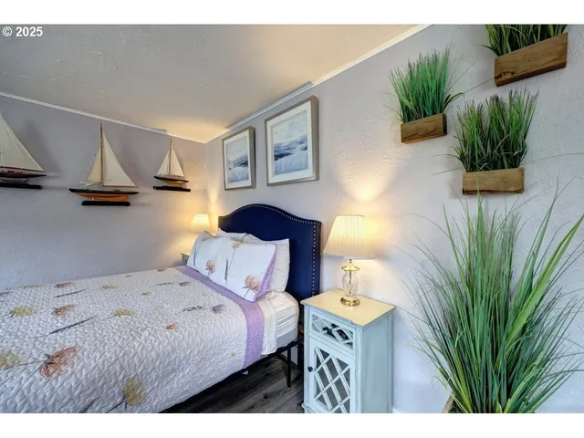 a bedroom with a bed and a potted plant