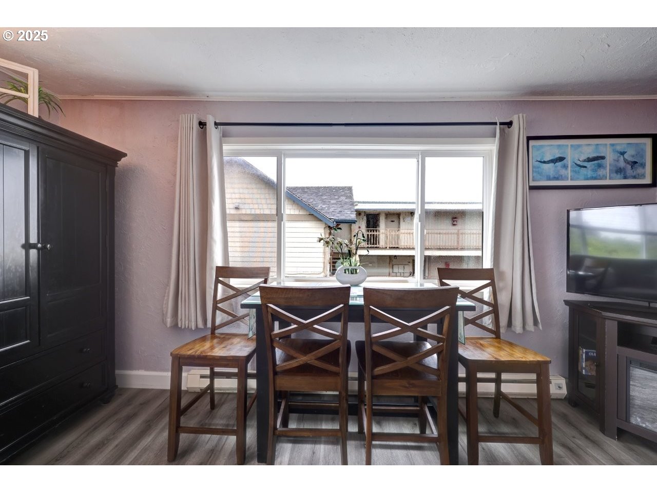 1022 North Prom Tradewinds, Unit 208 Seaside, OR 97138 - Photo 14 of 34 a view of a dining room with furniture and a window