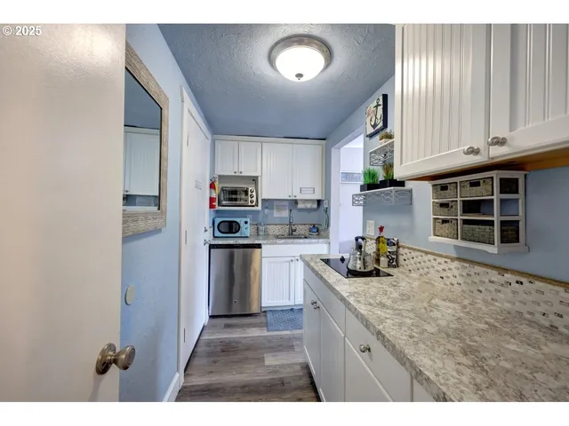 a kitchen with refrigerator and cabinets