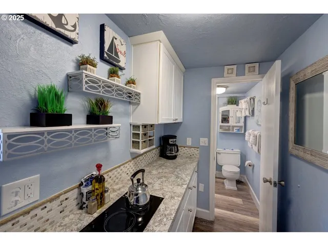 a kitchen view of a refrigerator and a sink
