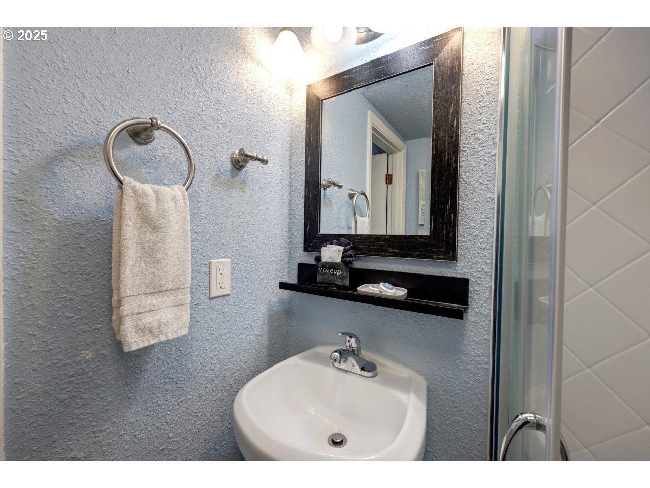 1022 North Prom Tradewinds, Unit 208 Seaside, OR 97138 - Photo 20 of 34 a bathroom with a sink and a mirror