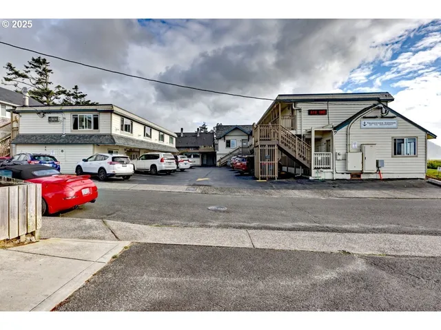 a view of a cars park in front of a building