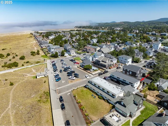 an aerial view of residential houses with outdoor space