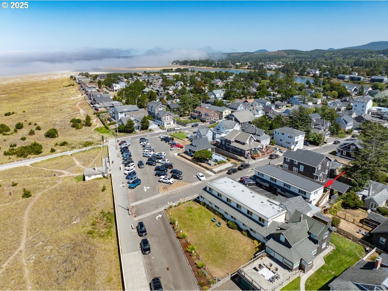 1022 North Prom Tradewinds, Unit 208 Seaside, OR 97138 - Photo 25 of 34 an aerial view of residential houses with outdoor space