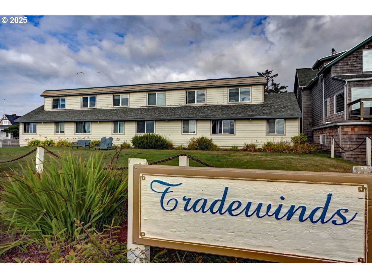 1022 North Prom Tradewinds, Unit 208 Seaside, OR 97138 - Photo 3 of 34 a front view of a house with a garden