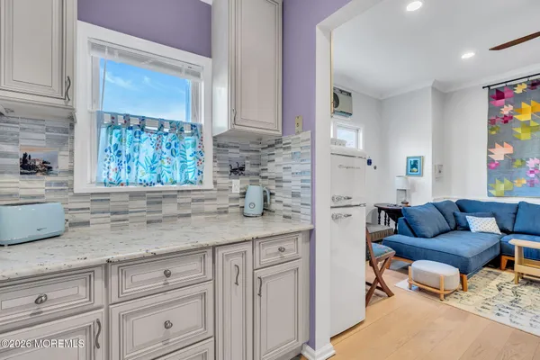 a kitchen with stainless steel appliances granite countertop a stove microwave and cabinets