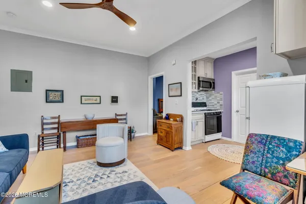 a living room with furniture a rug and a painting on the wall