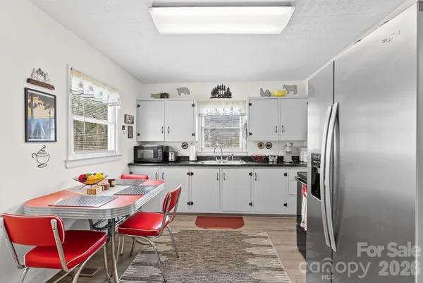 a kitchen with a refrigerator and a sink