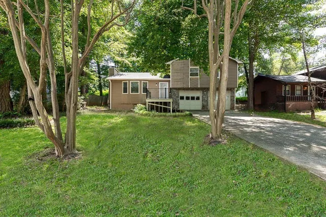 a backyard of a house with table and chairs