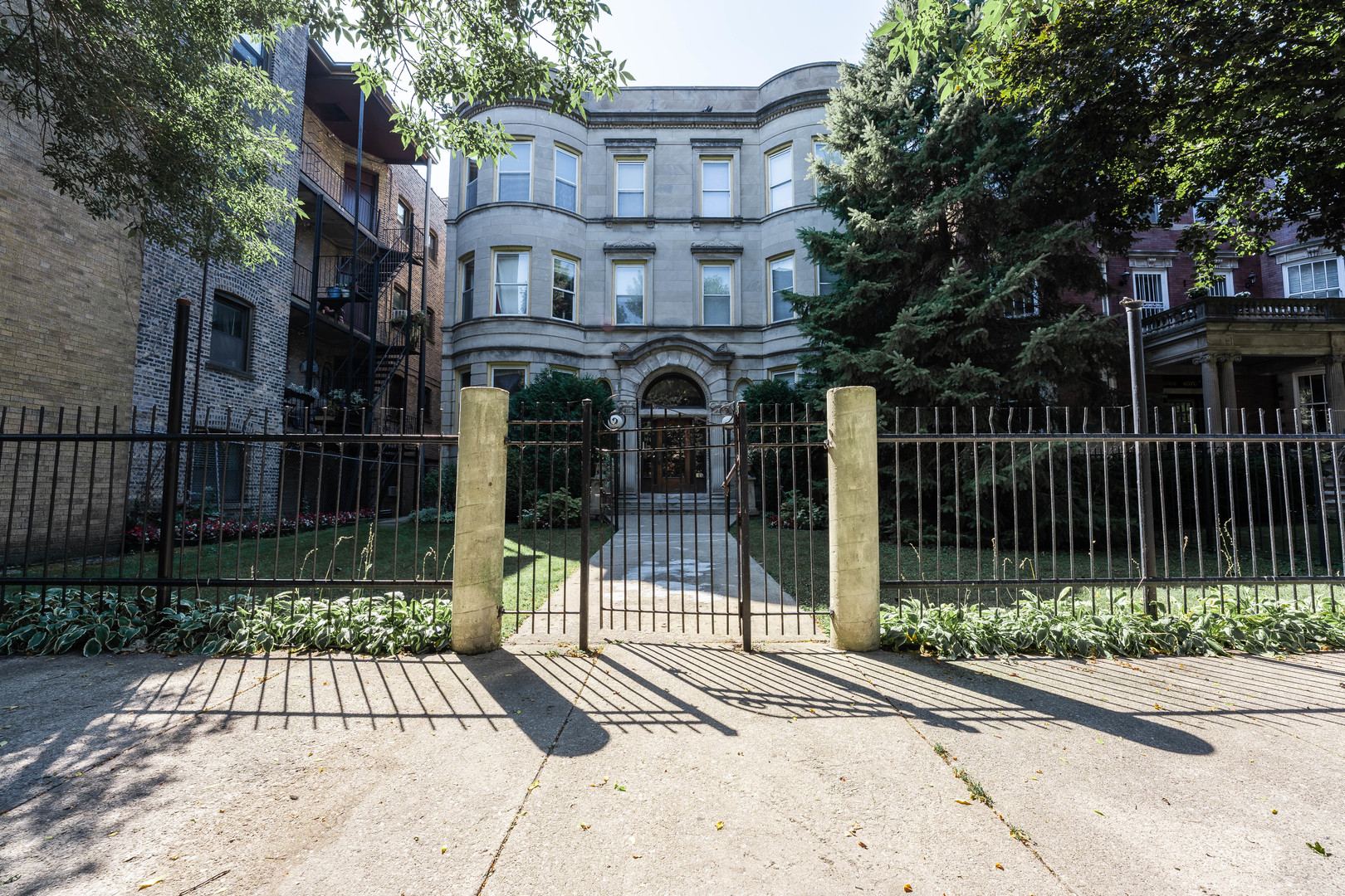 4060 North Sheridan Road, Unit 3S Chicago, IL 60613 - Photo 1 of 15 a view of a brick house with large windows and a small yard