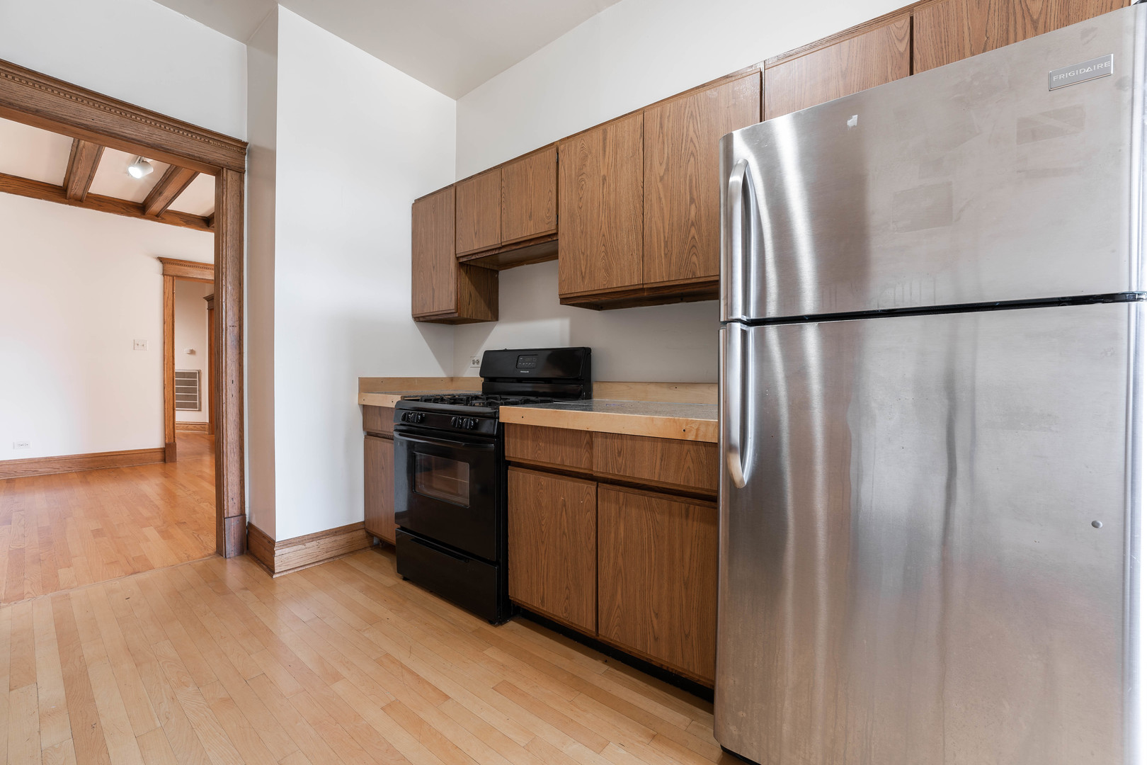 4060 North Sheridan Road, Unit 3S Chicago, IL 60613 - Photo 11 of 15 a kitchen with a refrigerator and a stove top oven