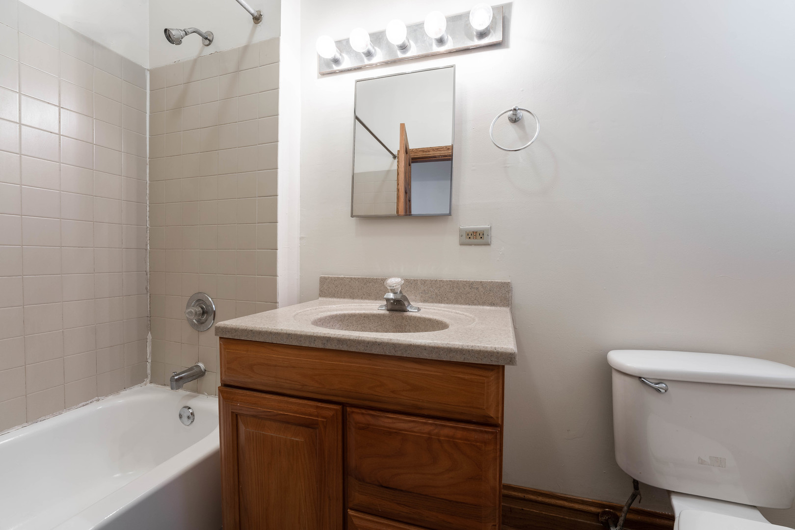 4060 North Sheridan Road, Unit 3S Chicago, IL 60613 - Photo 13 of 15 a bathroom with a sink toilet a mirror and shower