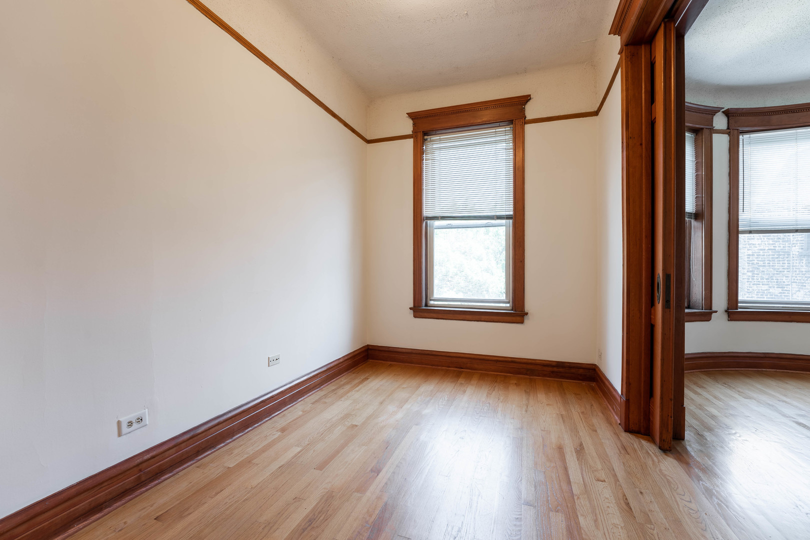 4060 North Sheridan Road, Unit 3S Chicago, IL 60613 - Photo 15 of 15 a view of an empty room with wooden floor and a window