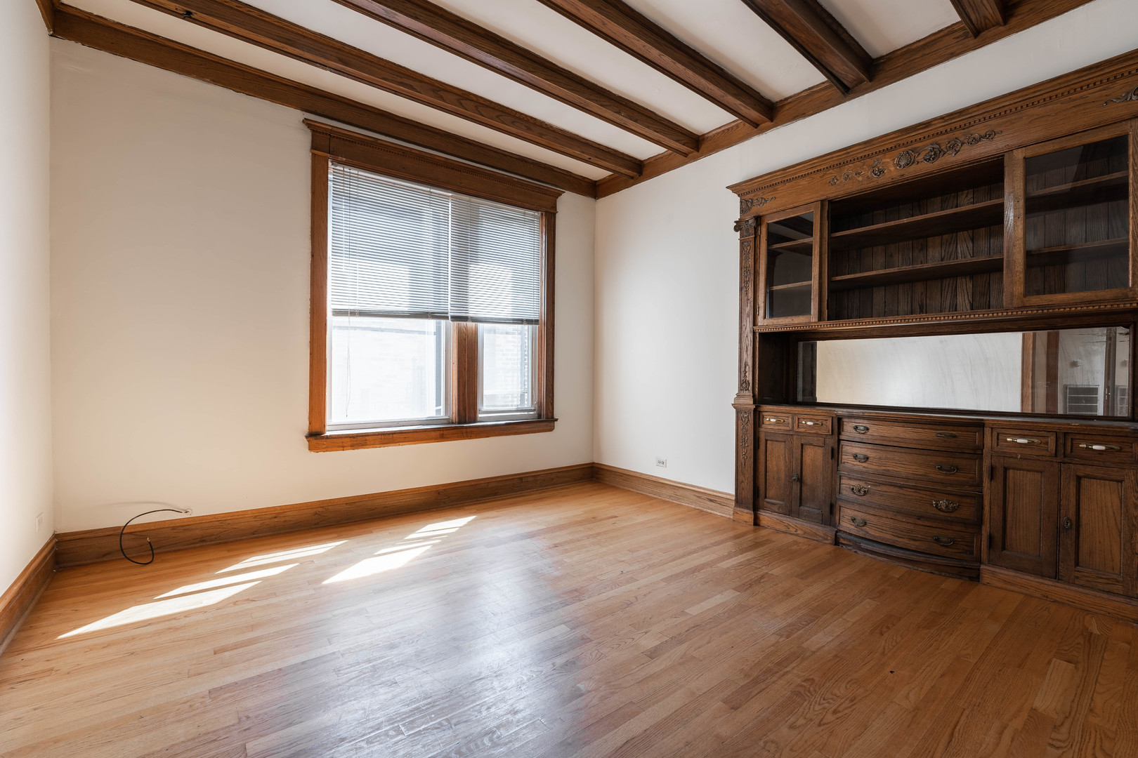 4060 North Sheridan Road, Unit 3S Chicago, IL 60613 - Photo 6 of 15 an empty room with wooden floor and cabinet