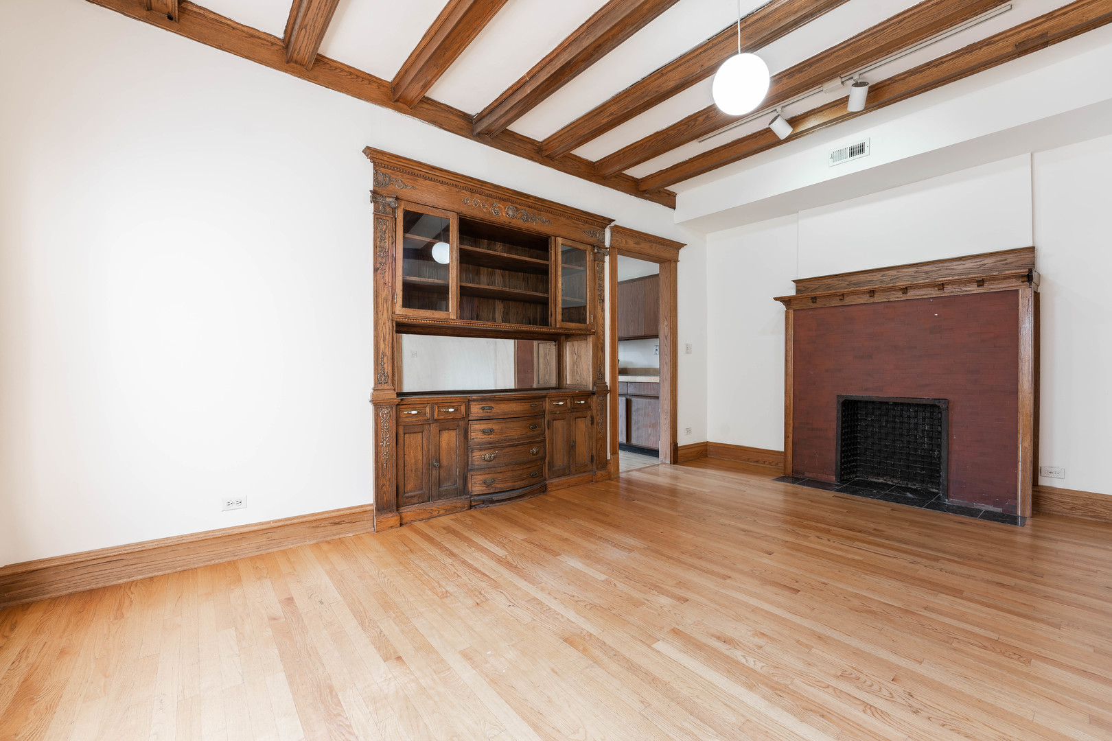 4060 North Sheridan Road, Unit 3S Chicago, IL 60613 - Photo 7 of 15 a view of empty room with a fireplace and wooden floor