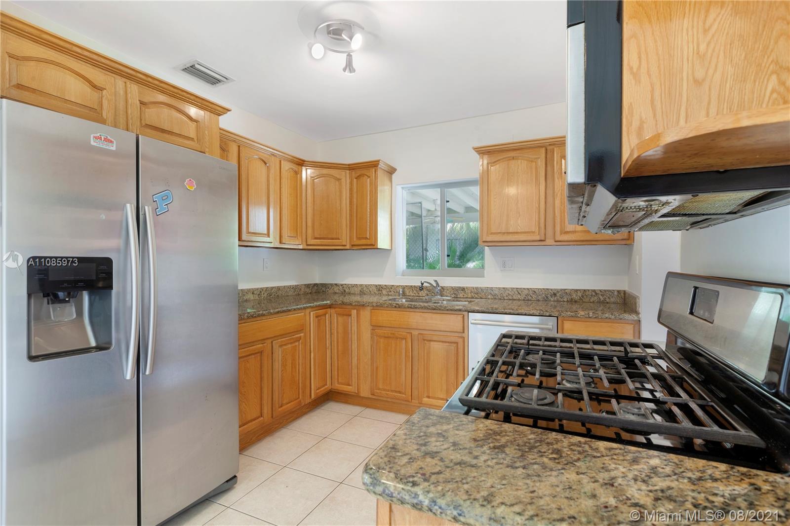 12501 Southwest 84th Avenue Road Miami, FL 33156 - Photo 11 of 20 a kitchen with stainless steel appliances granite countertop a refrigerator and a stove