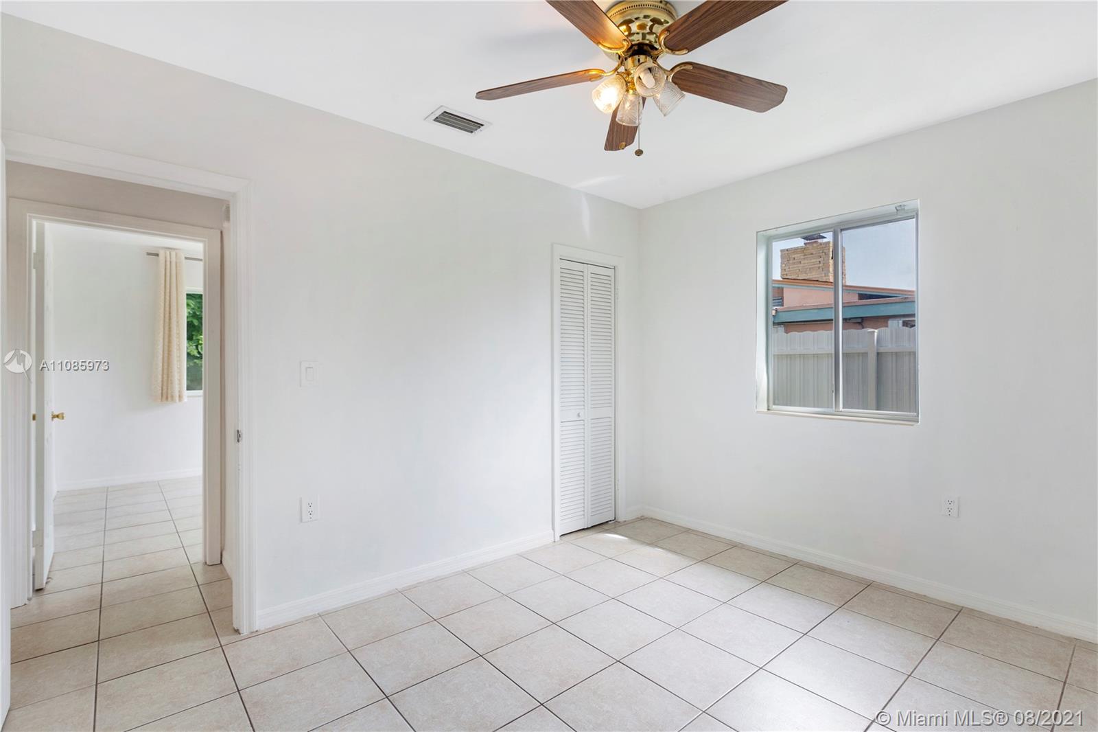 12501 Southwest 84th Avenue Road Miami, FL 33156 - Photo 14 of 20 an empty room with closet and a chandelier fan