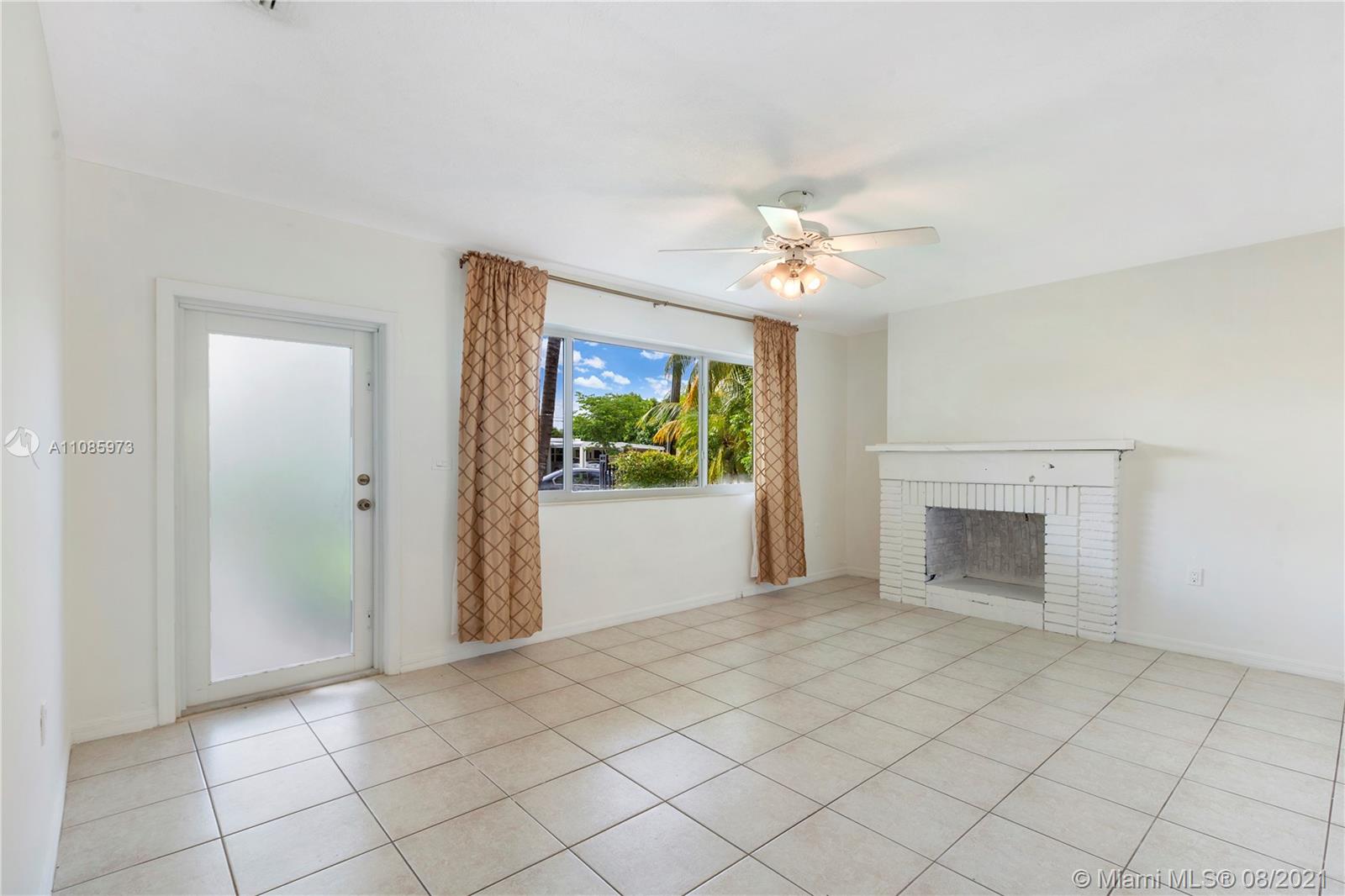 12501 Southwest 84th Avenue Road Miami, FL 33156 - Photo 5 of 20 a view of an empty room with a fireplace