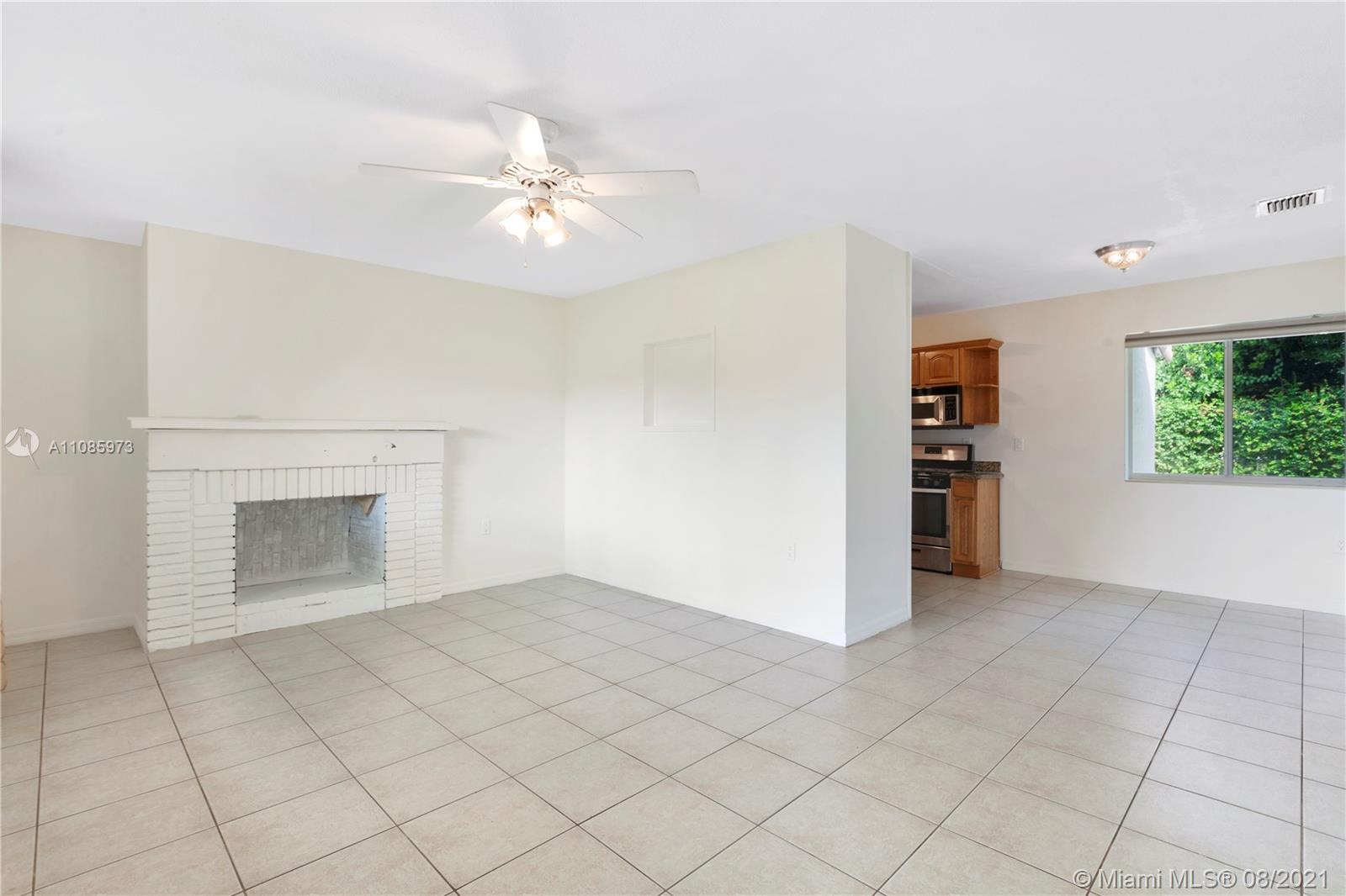 12501 Southwest 84th Avenue Road Miami, FL 33156 - Photo 6 of 20 an empty room with windows and fireplace