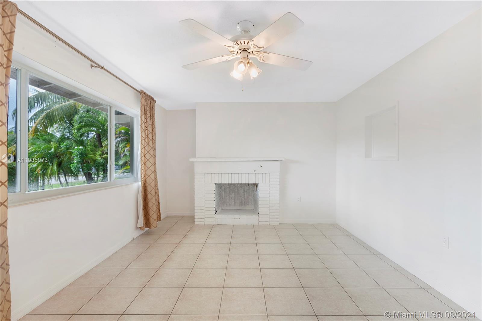 12501 Southwest 84th Avenue Road Miami, FL 33156 - Photo 7 of 20 an empty room with windows and ceiling fan